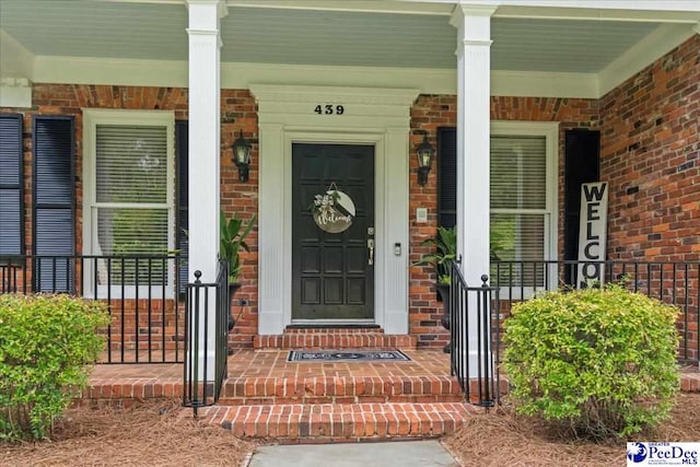 439 Whitman Ave, Florence, SC 29501 - doorway to property featuring brick siding and covered porch
