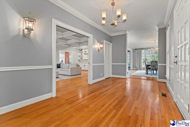 439 Whitman Ave, Florence, SC 29501 - entryway with a chandelier, crown molding, light wood-style flooring, coffered ceiling, and beam ceiling