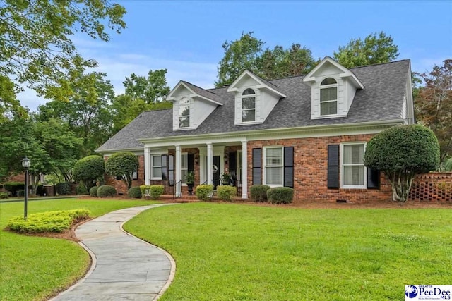 439 Whitman Ave, Florence, SC 29501 - new england style home with covered porch, brick siding, a front yard, and roof with shingles