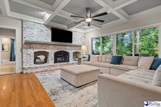 439 Whitman Ave, Florence, SC 29501 - living area featuring wood finished floors, a brick fireplace, beam ceiling, ceiling fan, and coffered ceiling
