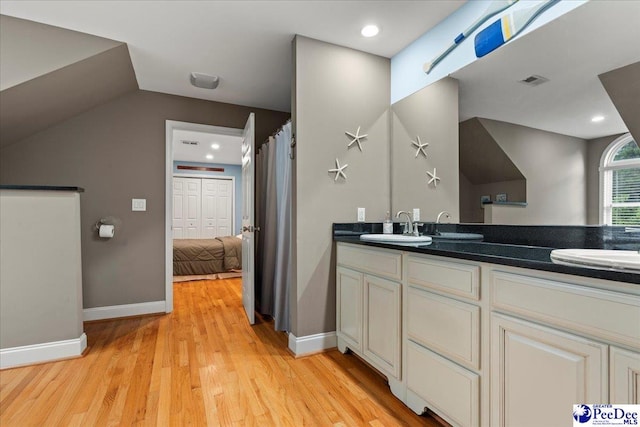 439 Whitman Ave, Florence, SC 29501 - full bath with double vanity, wood finished floors, vaulted ceiling, and recessed lighting