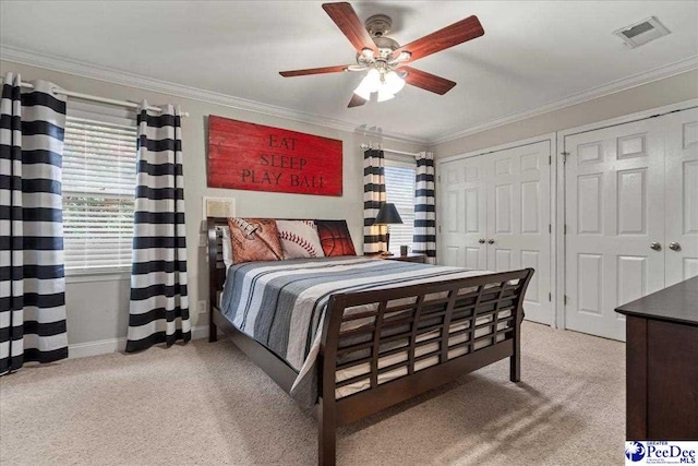 439 Whitman Ave, Florence, SC 29501 - bedroom with light carpet, two closets, crown molding, and ceiling fan