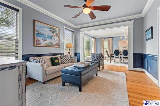 439 Whitman Ave, Florence, SC 29501 - living room with light wood-type flooring, ornamental molding, a ceiling fan, a chandelier, and wainscoting