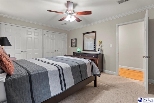 439 Whitman Ave, Florence, SC 29501 - bedroom with two closets, light carpet, crown molding, and ceiling fan
