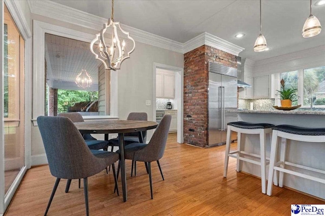 439 Whitman Ave, Florence, SC 29501 - dining area featuring a chandelier, light wood-style flooring, and ornamental molding