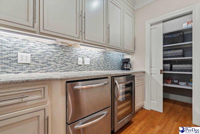 439 Whitman Ave, Florence, SC 29501 - kitchen with wine cooler, dishwasher, light wood-type flooring, and tasteful backsplash