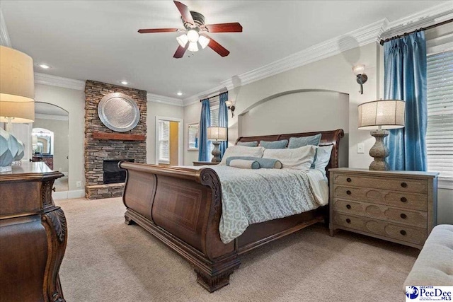 439 Whitman Ave, Florence, SC 29501 - carpeted bedroom featuring crown molding, a ceiling fan, recessed lighting, arched walkways, and a fireplace