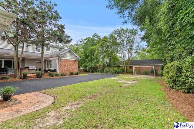 439 Whitman Ave, Florence, SC 29501 - view of grassy yard featuring driveway