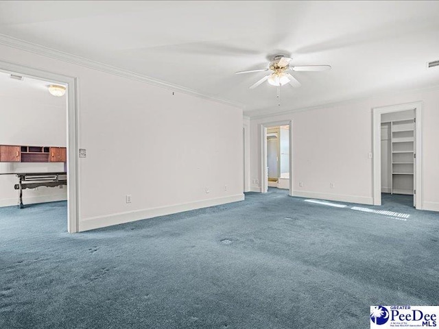 empty room featuring crown molding, ceiling fan, and carpet flooring