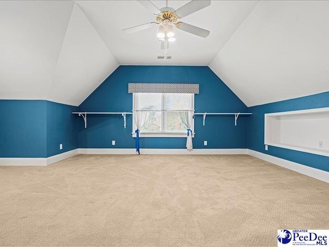 additional living space featuring vaulted ceiling, carpet floors, and ceiling fan