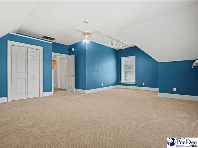 bonus room featuring light carpet, vaulted ceiling, and ceiling fan