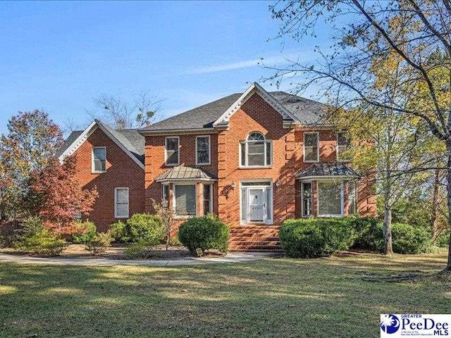 colonial-style house with a front yard