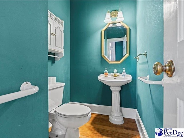 bathroom with wood-type flooring and toilet