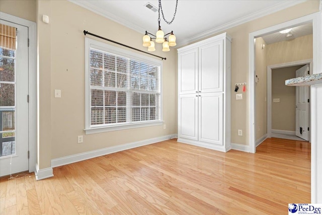 unfurnished dining area featuring ornamental molding, light hardwood / wood-style floors, and plenty of natural light