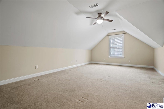 additional living space featuring lofted ceiling, light carpet, and ceiling fan