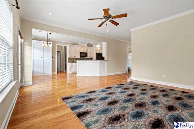 living room with ornamental molding, a healthy amount of sunlight, and light hardwood / wood-style floors