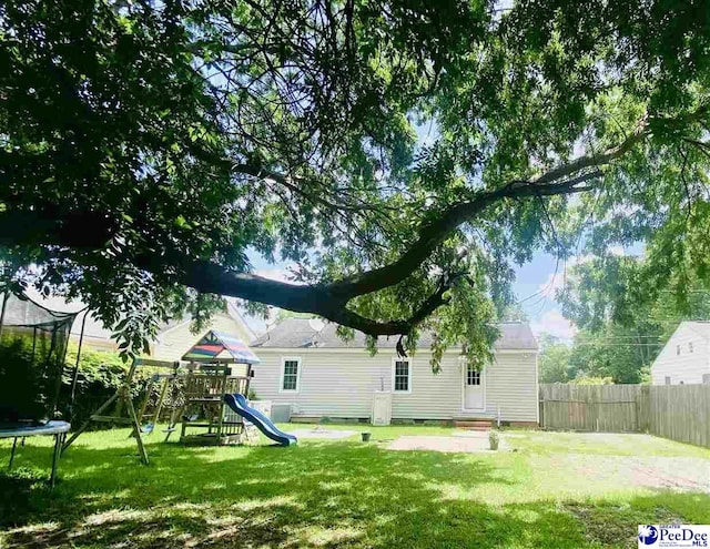 867 Congaree Dr, Florence, SC 29501 - view of yard with a trampoline, a playground, and entry steps