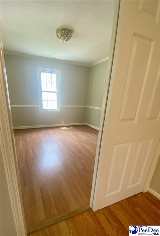 867 Congaree Dr, Florence, SC 29501 - empty room featuring wood finished floors, crown molding, and baseboards