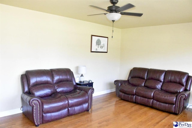 living room with wood-type flooring and ceiling fan