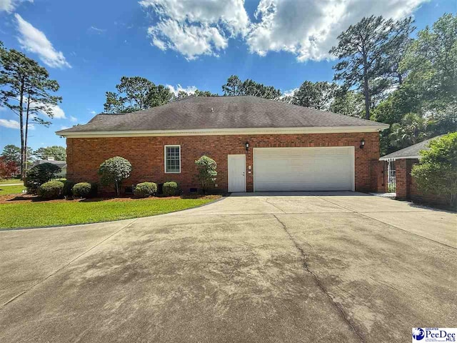 1219 Richard St, Dillon, SC 29536 - view of front of home featuring driveway, an attached garage, and brick siding