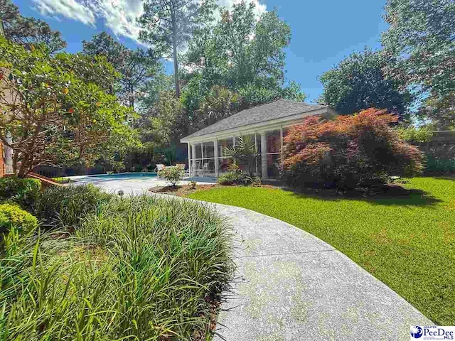 1219 Richard St, Dillon, SC 29536 - view of grassy yard with an outdoor pool and a sunroom