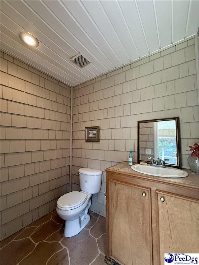 1219 Richard St, Dillon, SC 29536 - half bath featuring tile walls, toilet, and vanity
