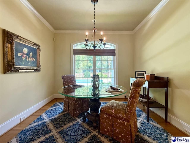 1219 Richard St, Dillon, SC 29536 - dining space with a chandelier, baseboards, wood finished floors, and crown molding