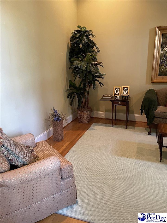sitting room featuring wood finished floors and baseboards