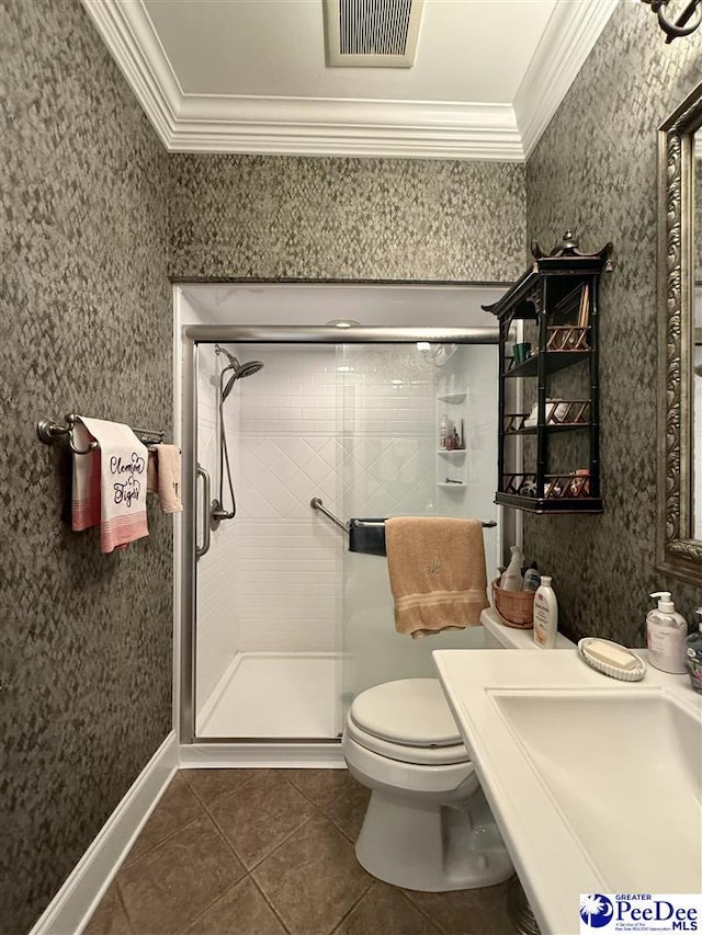 1219 Richard St, Dillon, SC 29536 - bathroom featuring ornamental molding, a shower stall, tile patterned flooring, toilet, and a sink