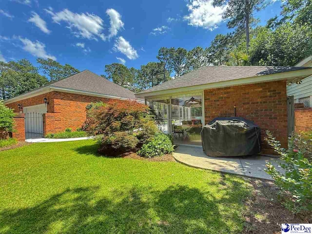 1219 Richard St, Dillon, SC 29536 - view of grassy yard with a patio and an attached garage