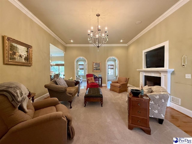 1219 Richard St, Dillon, SC 29536 - living room featuring arched walkways, a chandelier, baseboards, crown molding, and a fireplace