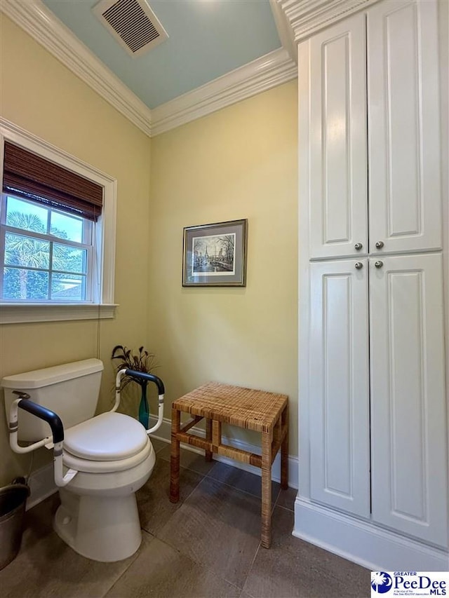 1219 Richard St, Dillon, SC 29536 - bathroom featuring toilet, ornamental molding, and baseboards
