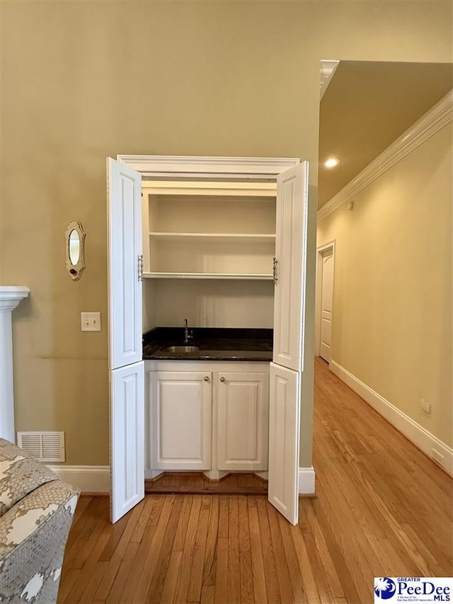 1219 Richard St, Dillon, SC 29536 - indoor wet bar featuring baseboards, light wood finished floors, and ornamental molding