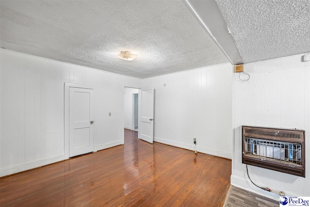 707 Chase St, Florence, SC 29501 - unfurnished living room featuring heating unit, a textured ceiling, and wood finished floors