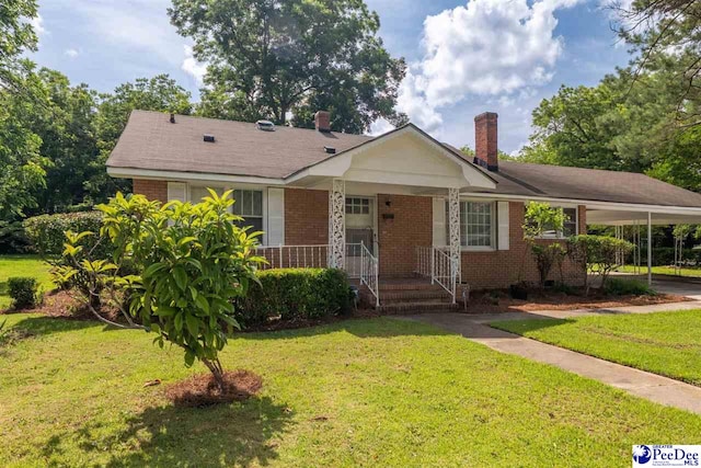 707 Chase St, Florence, SC 29501 - view of front of home featuring brick siding, a chimney, a front lawn, a porch, and an attached carport