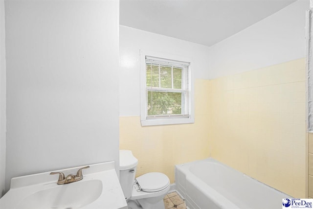707 Chase St, Florence, SC 29501 - full bathroom with tile walls, a tub to relax in, tile patterned flooring, and a wainscoted wall