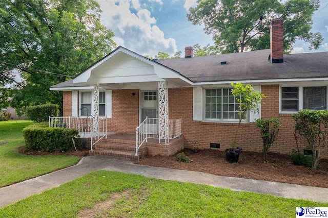 707 Chase St, Florence, SC 29501 - view of front of house with brick siding, a front yard, crawl space, and a chimney