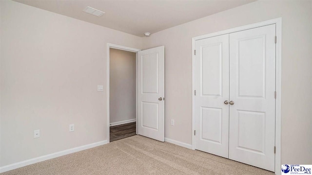 575 Strawberry Field Way, Galivants Ferry, SC 29544 - unfurnished bedroom with light colored carpet, baseboards, and a closet