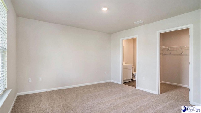 575 Strawberry Field Way, Galivants Ferry, SC 29544 - unfurnished bedroom featuring carpet floors, a walk in closet, baseboards, and a closet