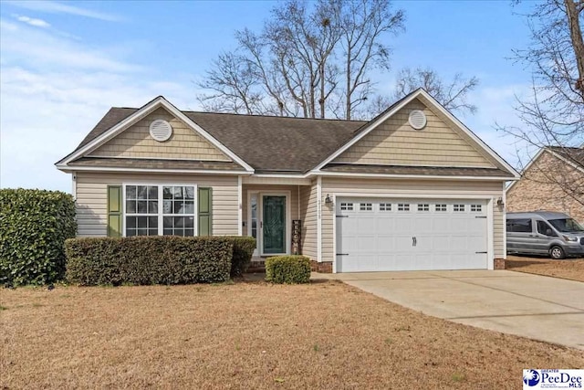 view of front facade featuring a garage and a front lawn