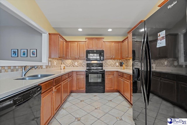 kitchen with sink, black appliances, light tile patterned flooring, and decorative backsplash