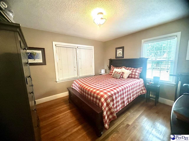 59 Lynn Ave, Cheraw, SC 29520 - bedroom with baseboards, wood finished floors, and a textured ceiling