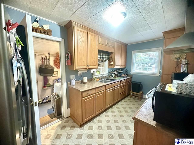 59 Lynn Ave, Cheraw, SC 29520 - kitchen featuring wall chimney range hood, a sink, light floors, light countertops, and baseboards