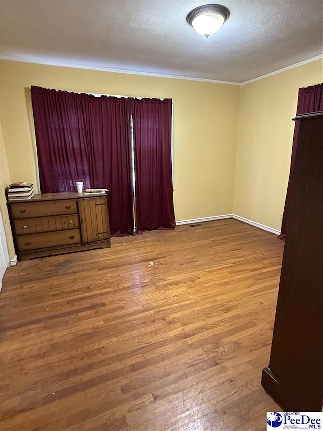 68 Victory Dr, Cheraw, SC 29520 - spare room featuring ornamental molding, light hardwood / wood-style flooring, and a textured ceiling