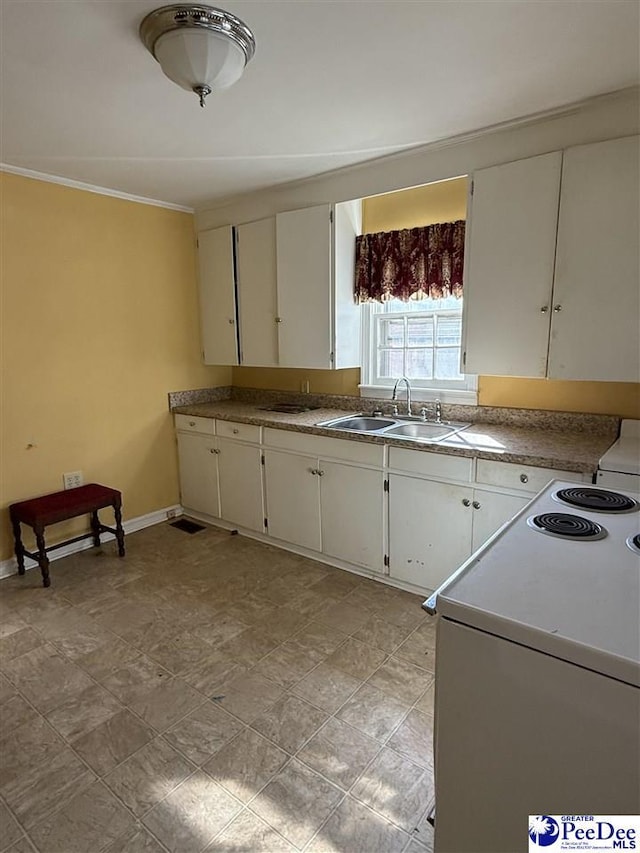 68 Victory Dr, Cheraw, SC 29520 - kitchen with range with electric stovetop, ornamental molding, sink, and white cabinets