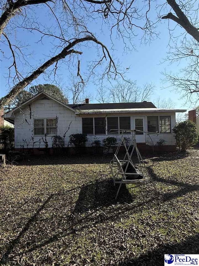 view of front facade with a sunroom