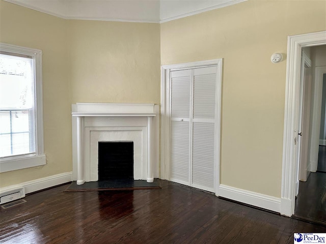 101 W Baptist St, Marion, SC 29571 - unfurnished living room featuring dark wood-style floors, healthy amount of natural light, crown molding, and a fireplace