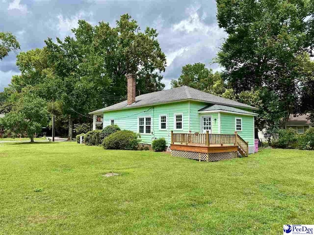 101 W Baptist St, Marion, SC 29571 - rear view of property featuring a deck, a yard, and a chimney