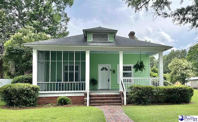 101 W Baptist St, Marion, SC 29571 - bungalow-style house with a chimney, a porch, a front yard, and roof with shingles