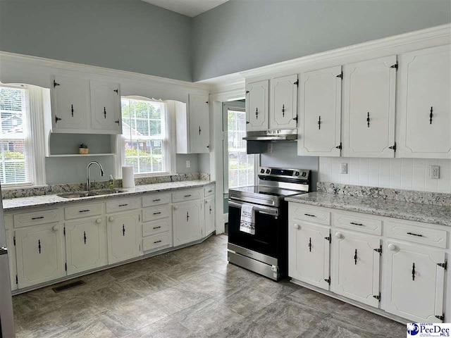101 W Baptist St, Marion, SC 29571 - kitchen with stainless steel electric range, under cabinet range hood, white cabinets, and open shelves